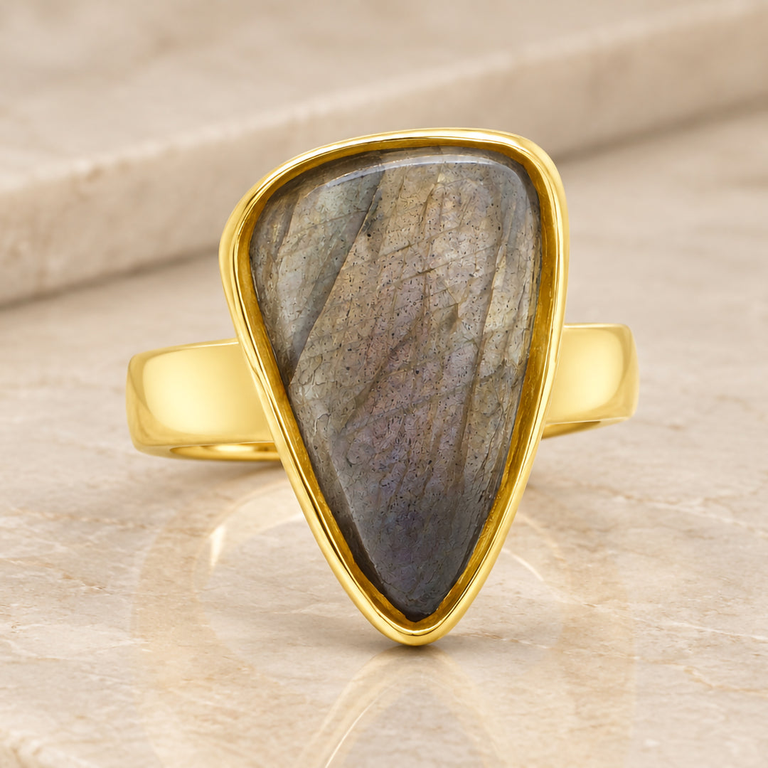 Front view of the pear shaped labradorite in its custom 14 karat yellow gold bezel-style mounting
