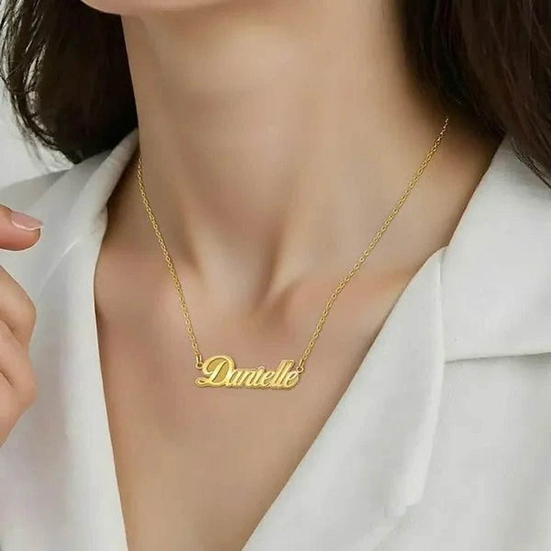 Model wearing the 14 Karat Fancy Script Name Necklace in 14K yellow gold personalized with the name Danielle | AJ's Jewelry