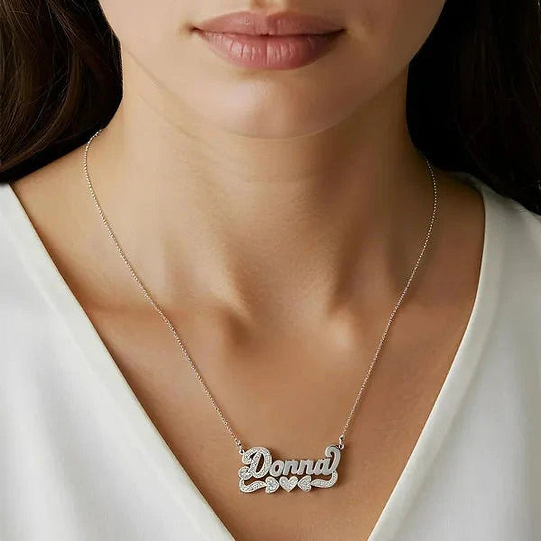 Model wearing the 14 Karat 3D Name Necklace with Three Hearts in 14K white gold personalized with the name Donna | AJ's Jewelry