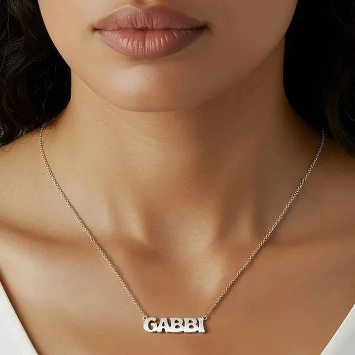 Model wearing the Sterling Silver Retro Letter Style Name Necklace personalized with the name Gabbi | AJ's Jewelry