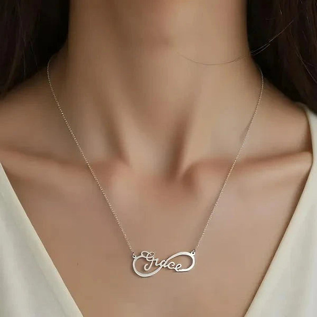 Model wearing the 14 Karat Infinity Style Name Necklace in 14K white gold personalized with the name Grace | AJ's Jewelry