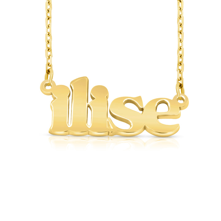 A gold nameplate necklace spelling 'ilise', hanging from a delicate gold chain against a white background.  This photo can change appearance depending on the name input using the custom name builder
