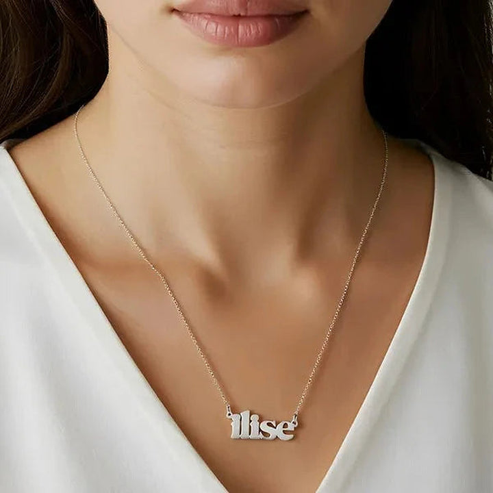 Model wearing the 14 Karat Lowercase Bold Name Necklace in 14K white gold personalized with the name Ilise | AJ's Jewelry