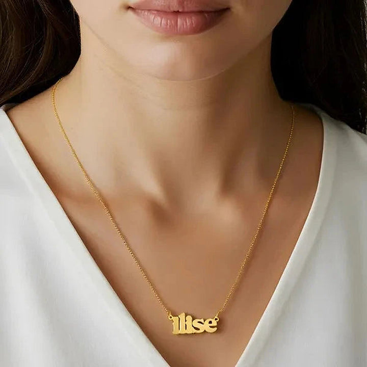 Model wearing the 14 Karat Lowercase Bold Name Necklace in 14K yellow gold personalized with the name Ilise | AJ's Jewelry