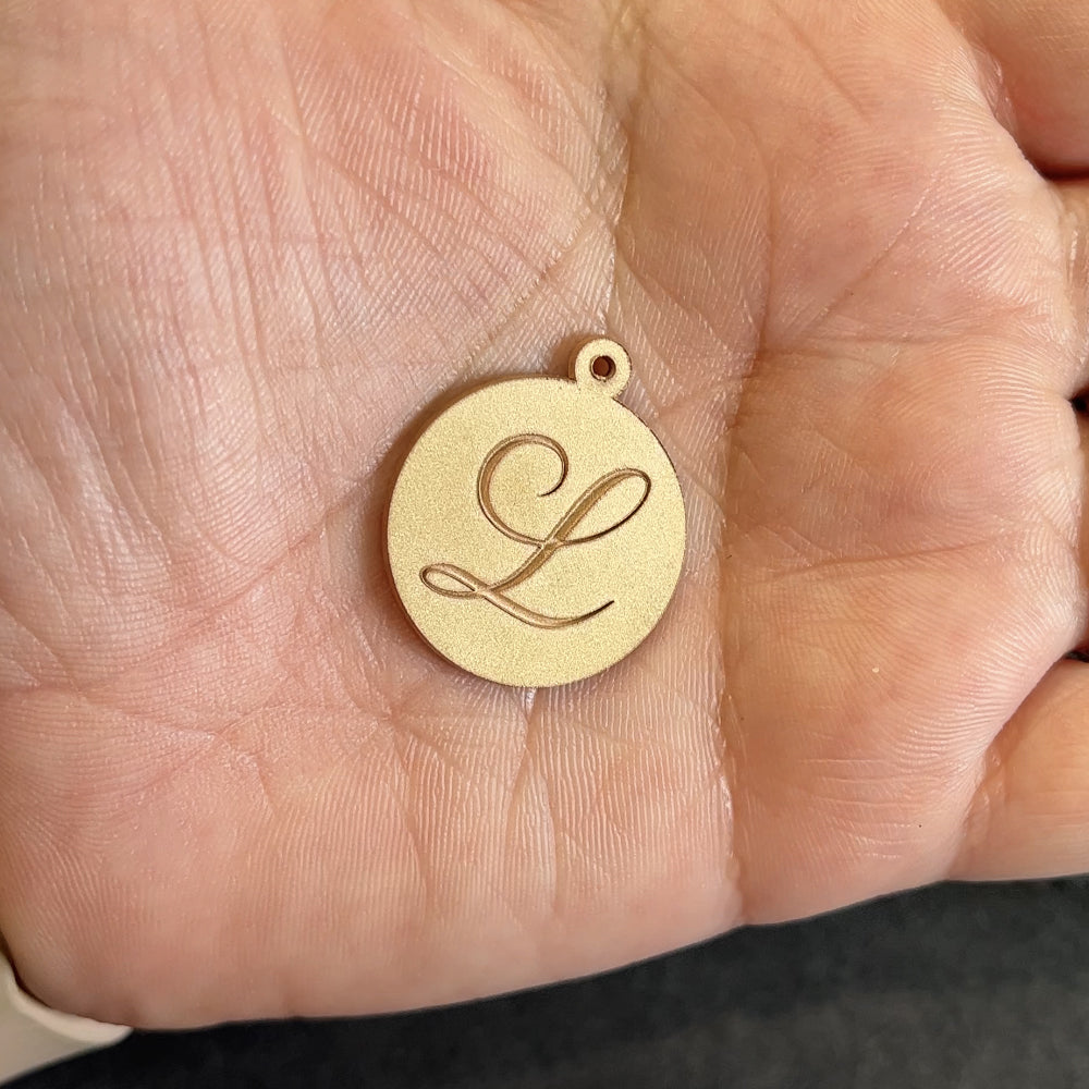 14kt yellow gold personalized initial disc pendant after laser engraving and cutting, before hand finishing at AJ's Jewelry Queens NY