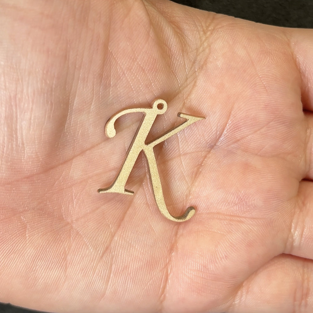 14kt yellow gold initial K pendant after laser engraving and cutting, before hand finishing at AJ's Jewelry Queens NY