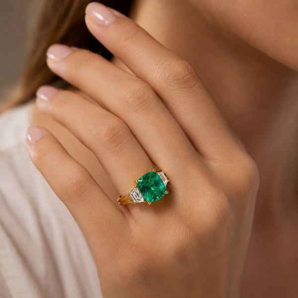 Lifestyle shot of the custom lab grown emerald 3-stone ring and matching wedding band set at AJ's Jewelry — Ridgewood Queens NY