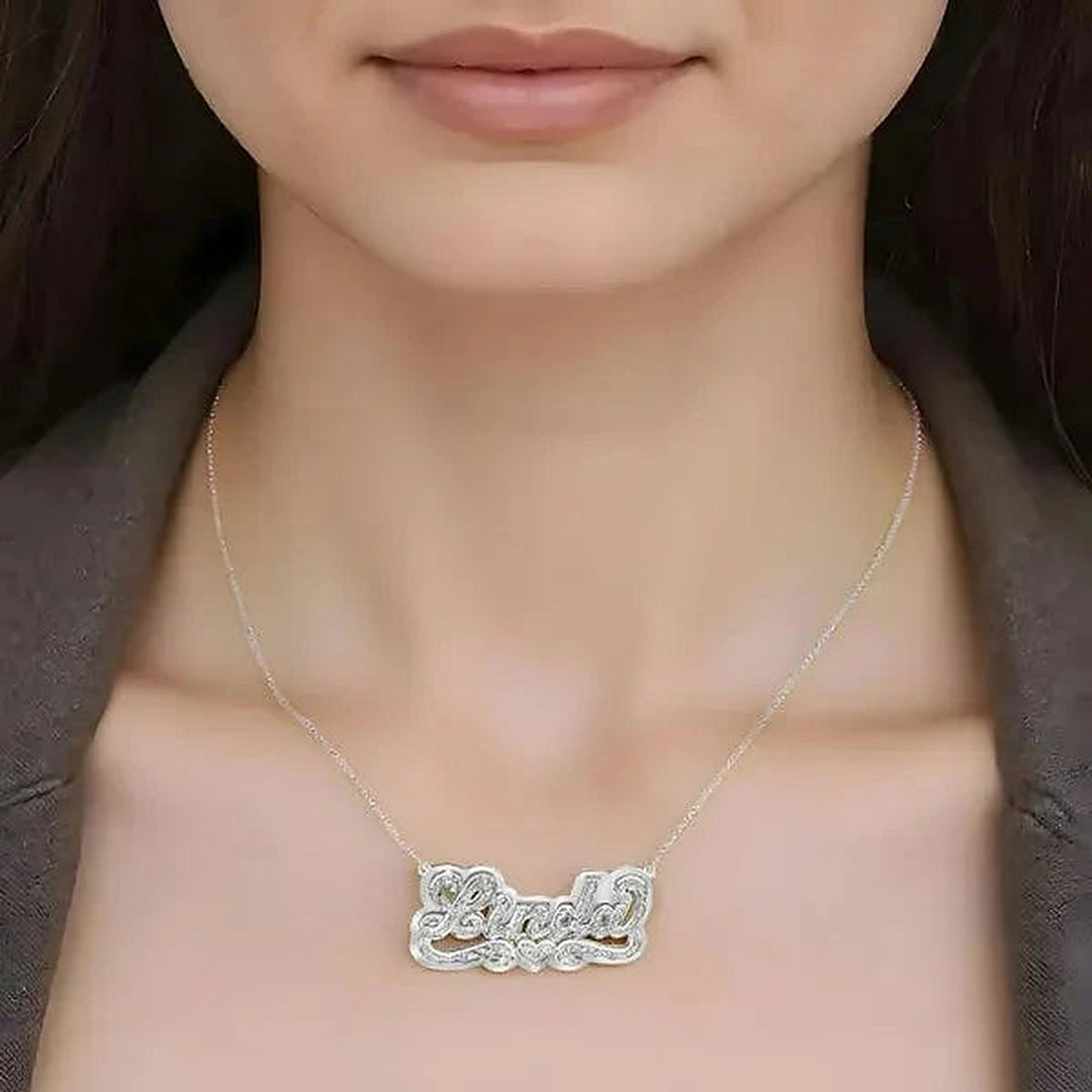 Model wearing the 14 Karat 3D Name Necklace with Solid Back Plate in 14K white gold personalized with the name Linda | AJ's Jewelry