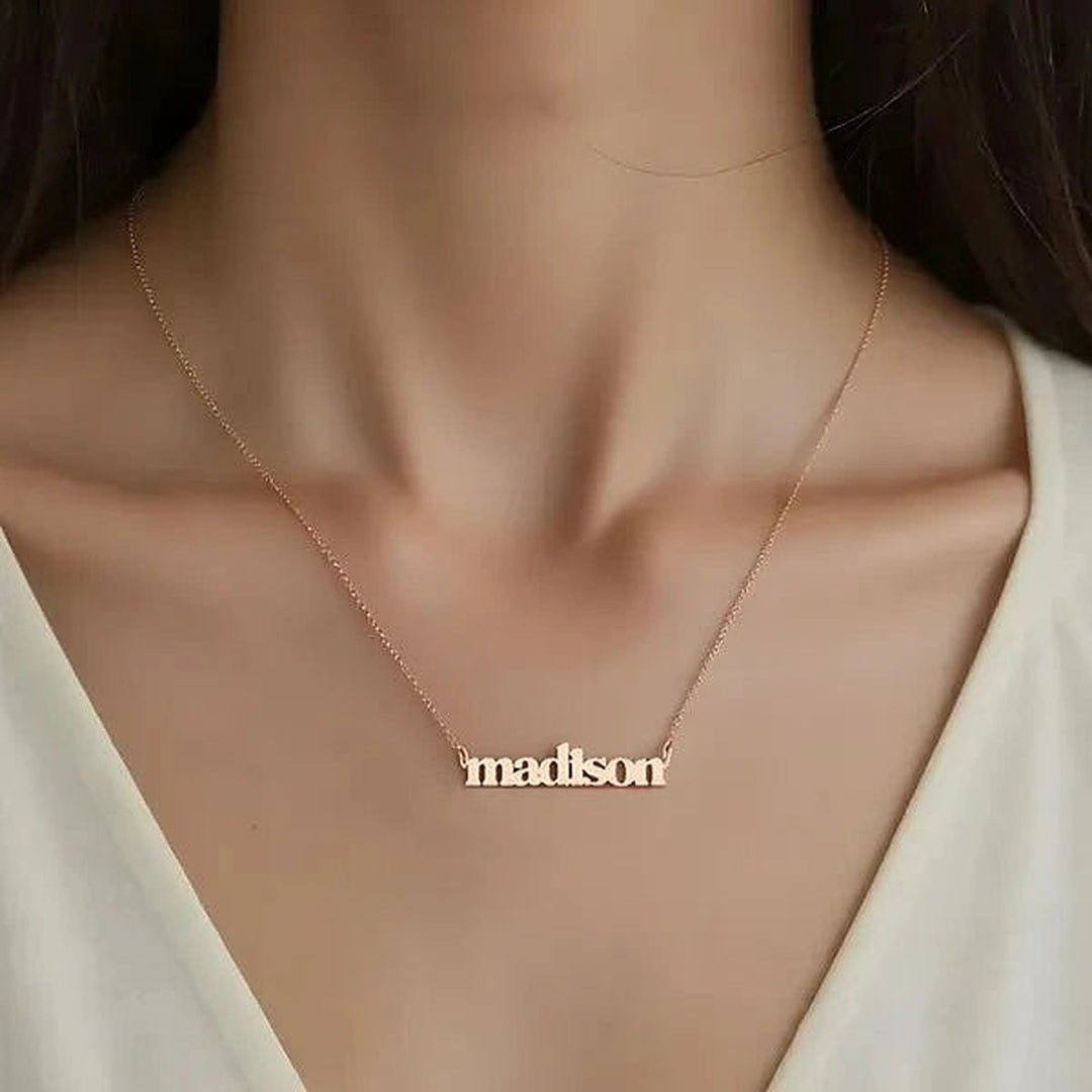 Model wearing the 14 Karat Lowercase Bold Name Necklace in 14K rose gold personalized with the name Madison | AJ's Jewelry