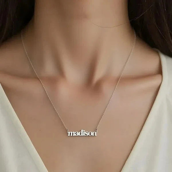 Model wearing the 14 Karat Lowercase Bold Name Necklace in 14K white gold personalized with the name Madison | AJ's Jewelry