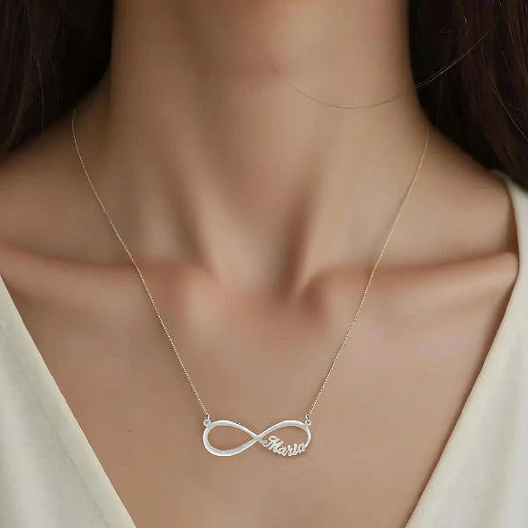 Model wearing the 14 Karat Infinity Name Necklace in 14K white gold personalized with the name Maria | AJ's Jewelry
