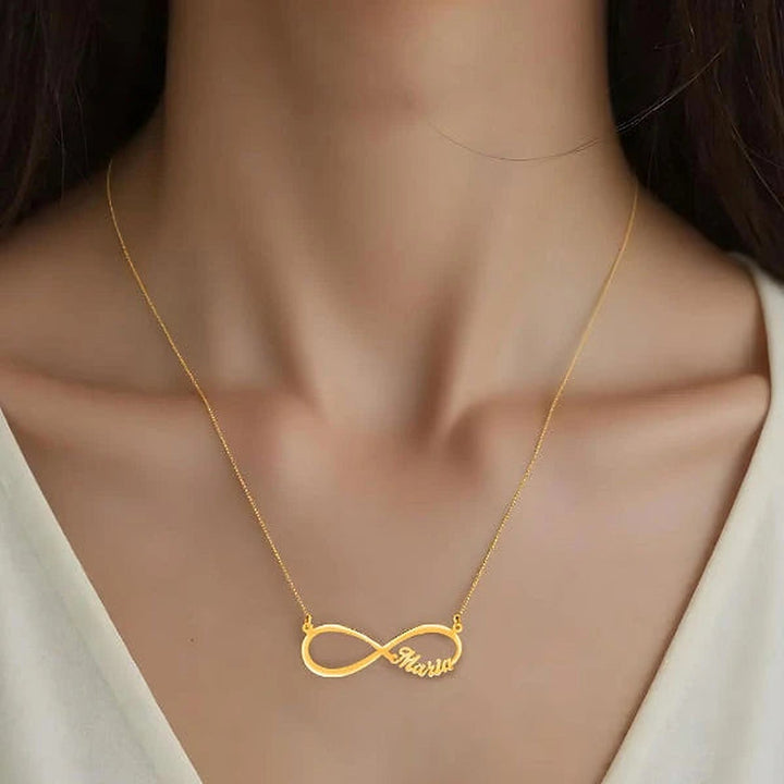 Model wearing the 14 Karat Infinity Name Necklace in 14K yellow gold personalized with the name Maria | AJ's Jewelry