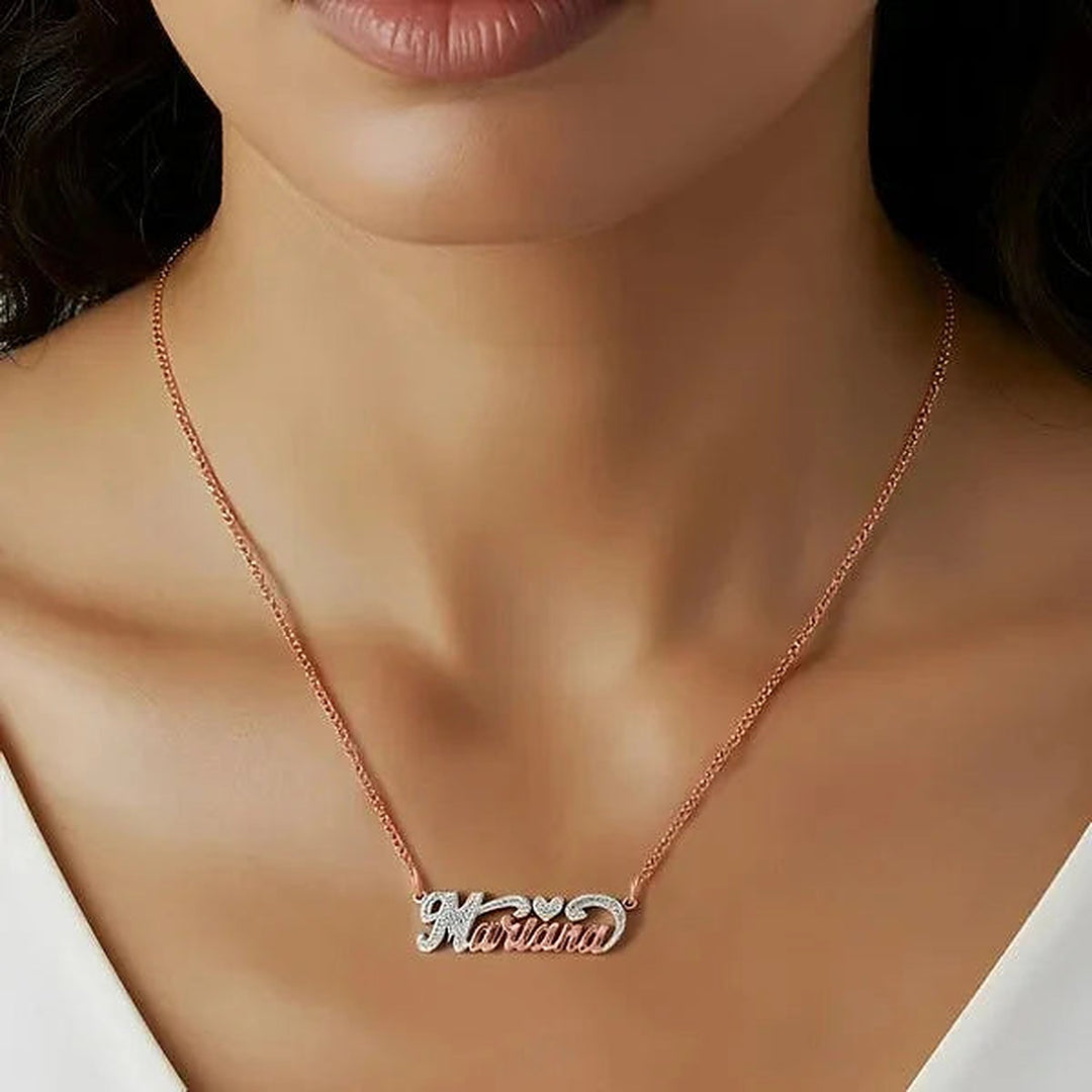 Model wearing the 14 Karat Small Name Necklace with Heart in 14K rose gold personalized with the name Marina | AJ's Jewelry
