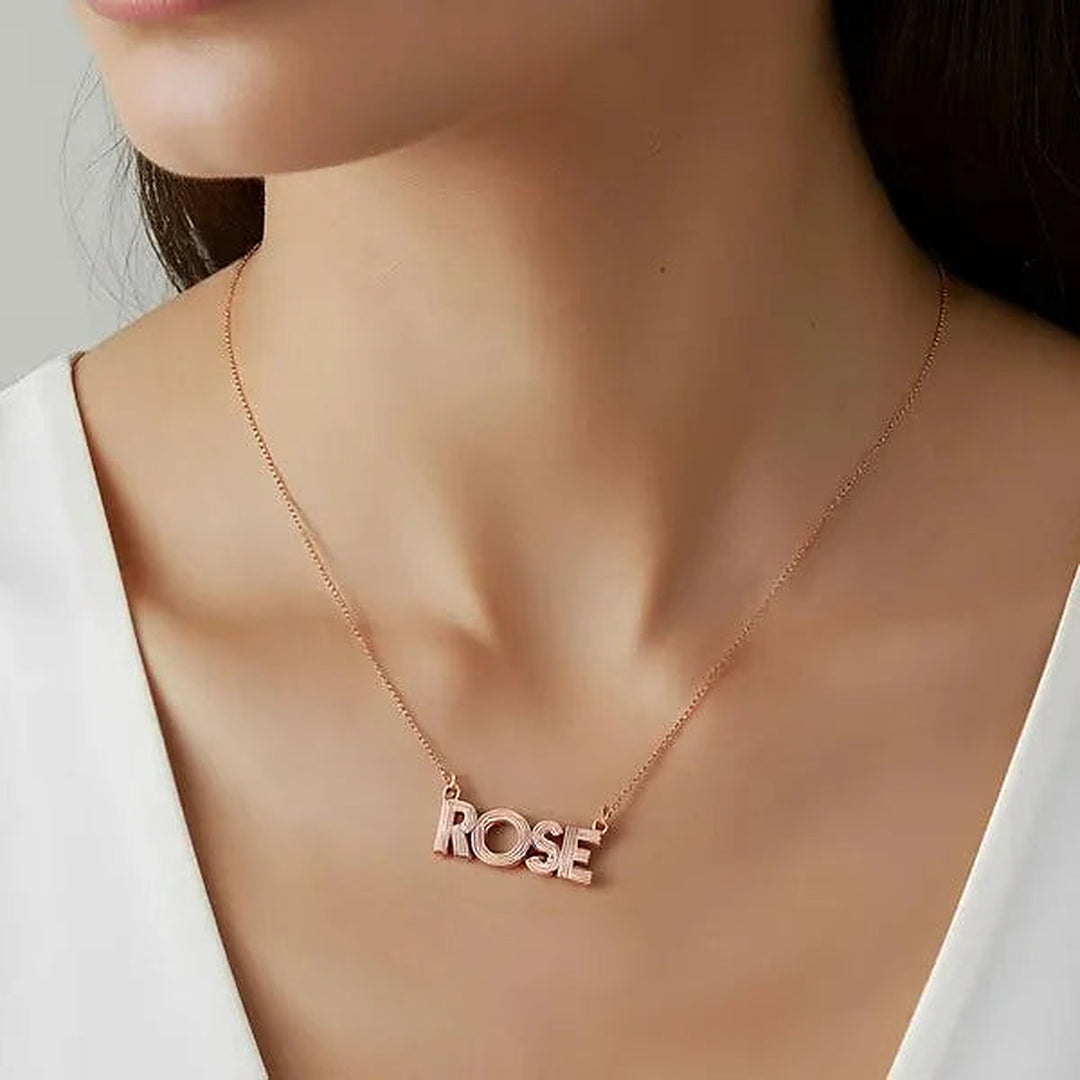 Model wearing the 14 Karat Fluted Name Necklace in 14K rose gold personalized with the name Rose | AJ's Jewelry