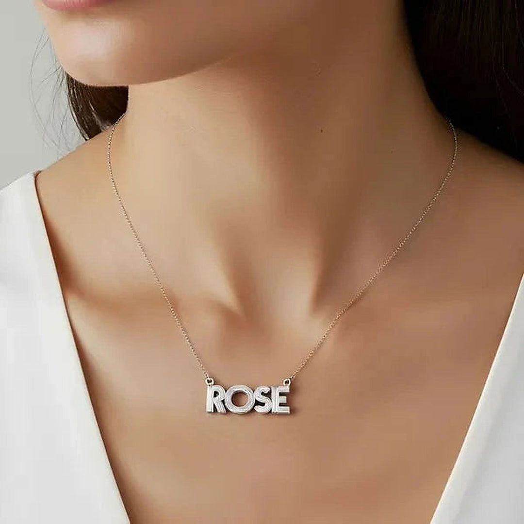 Model wearing the 14 Karat Fluted Name Necklace in 14K white gold personalized with the name Rose | AJ's Jewelry