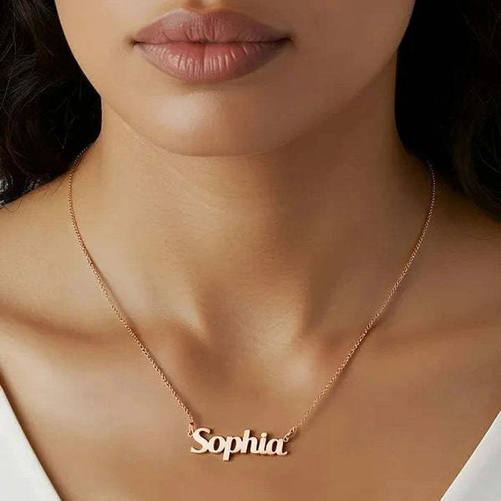 Model wearing the 14 Karat Bold Print Name Necklace in 14K rose gold personalized with the name Sophia | AJ's Jewelry