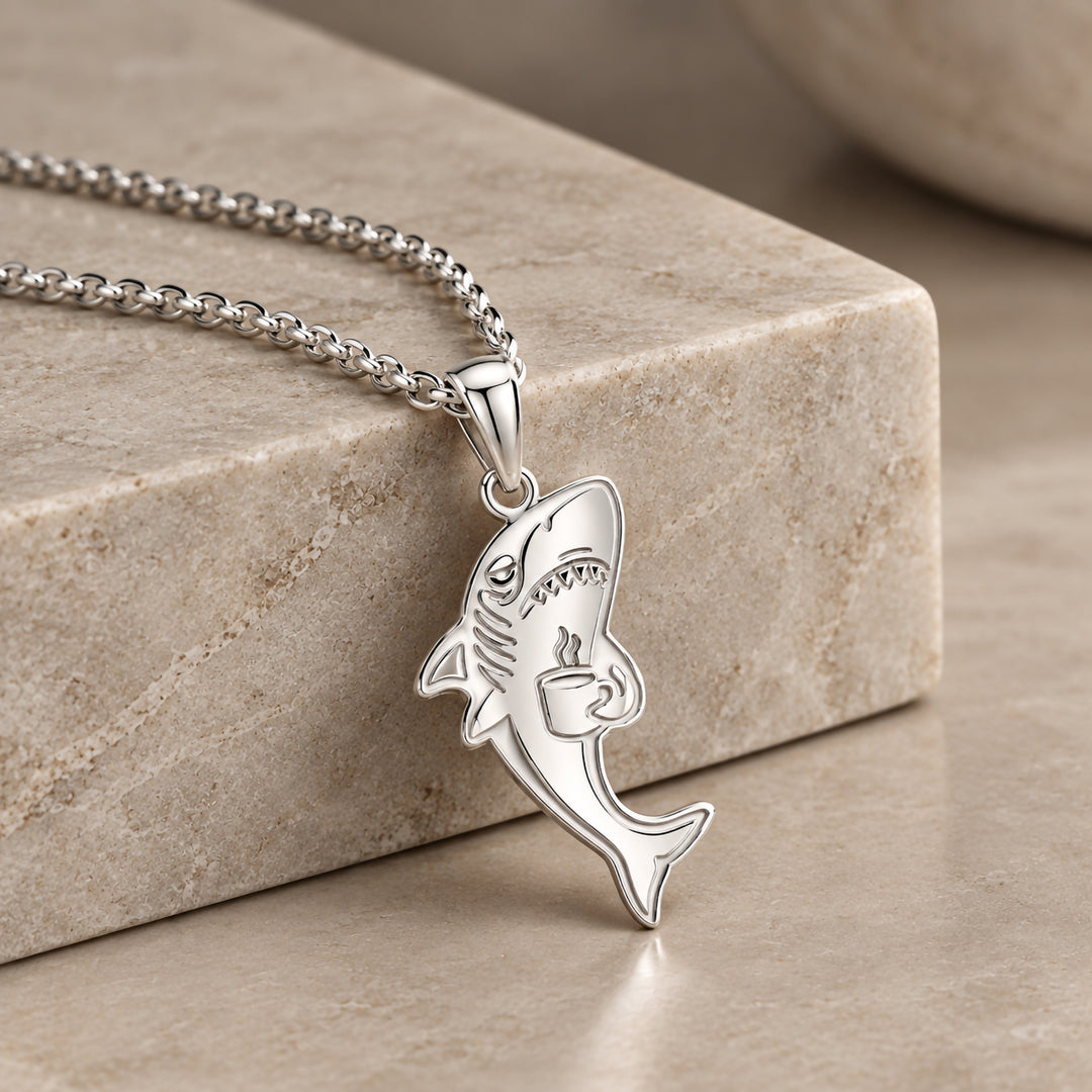 Finished sterling silver tired shark pendant with laser engraved detail, hanging on its chain