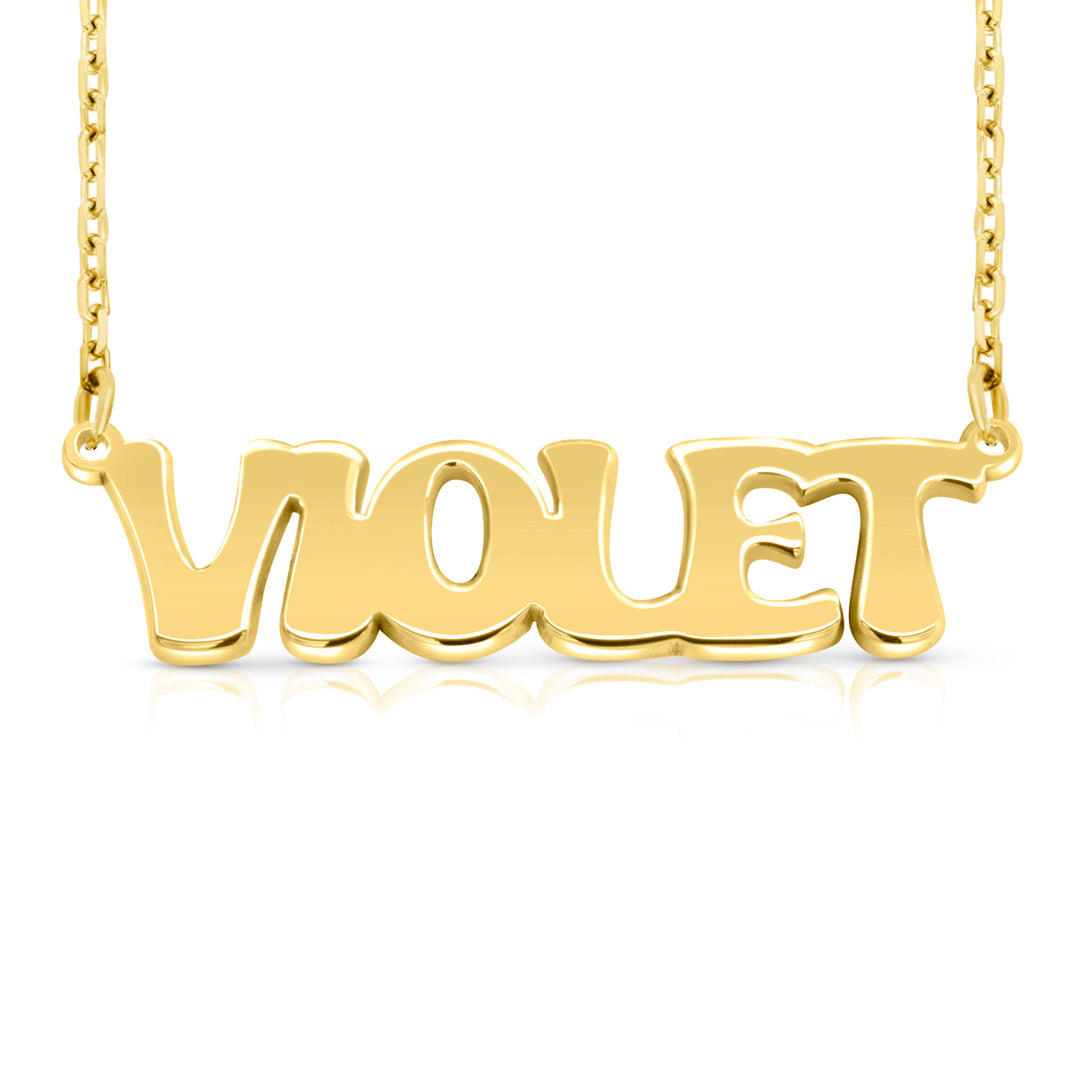 A gold nameplate necklace spelling 'VIOLET' in polished retro-style letters, suspended from a delicate gold chain on a white background.  This photo can change appearance depending on the name input using the custom name builder
