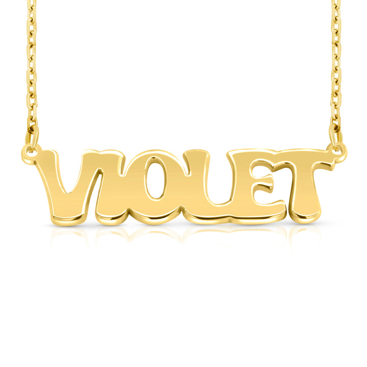 A gold nameplate necklace spelling 'VIOLET' in polished retro-style letters, suspended from a delicate gold chain on a white background.  This photo can change appearance depending on the name input using the custom name builder