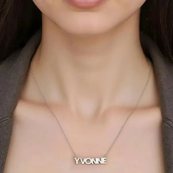 Model wearing the 14 Karat Fluted Name Necklace in 14K white gold personalized with the name Yvonne | AJ's Jewelry