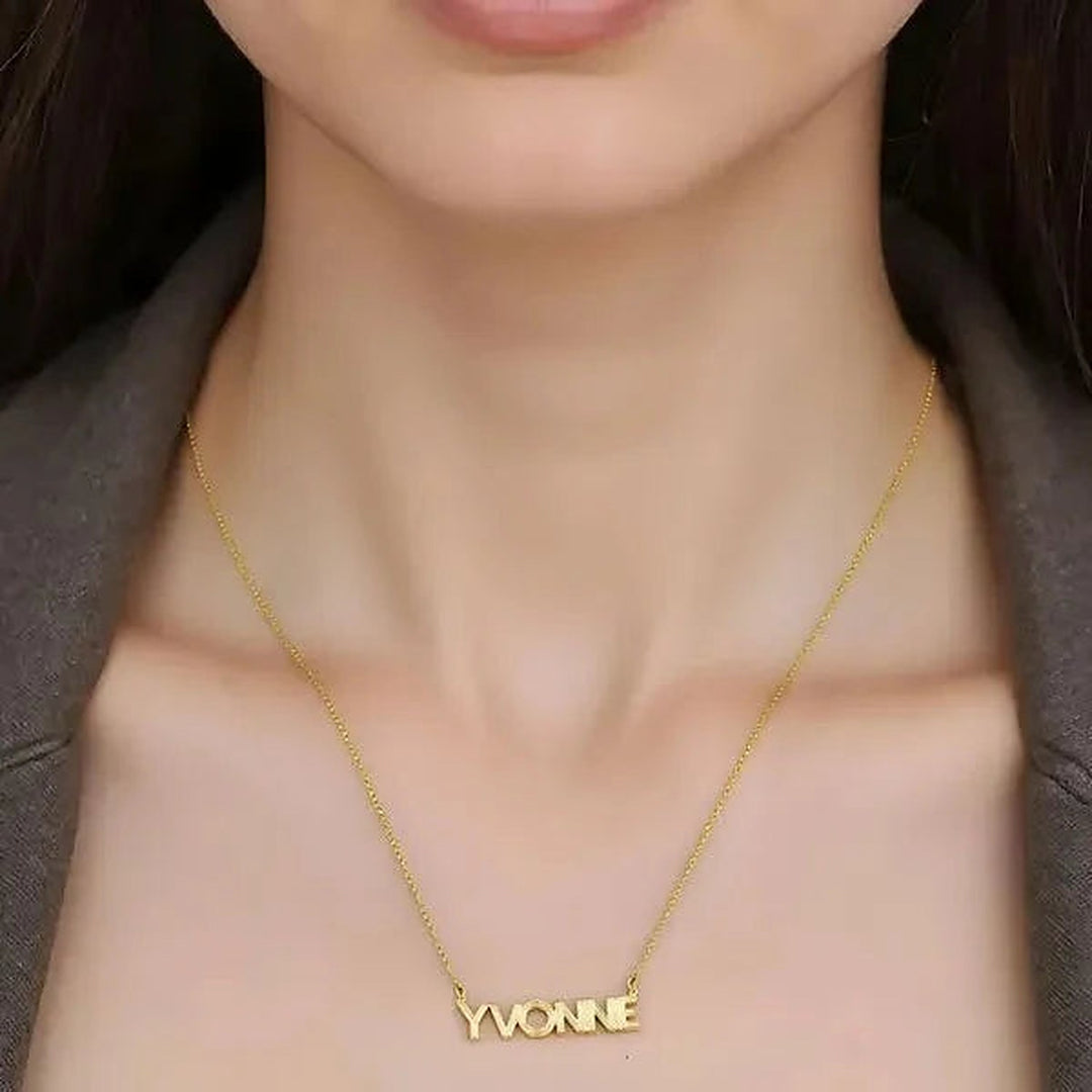 Model wearing the 14 Karat Fluted Name Necklace in 14K yellow gold personalized with the name Yvonne | AJ's Jewelry