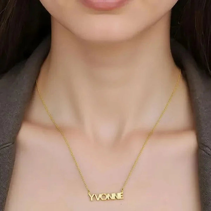 Model wearing the 14 Karat Fluted Name Necklace in 14K yellow gold personalized with the name Yvonne | AJ's Jewelry